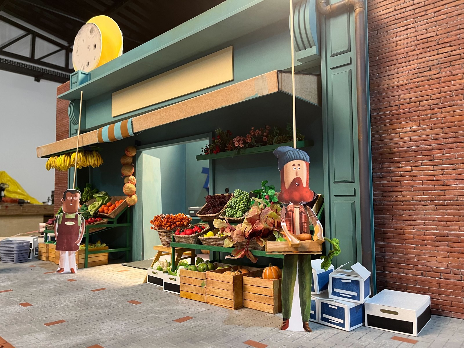 A hand built miniature market set with fruit and vegetable crates