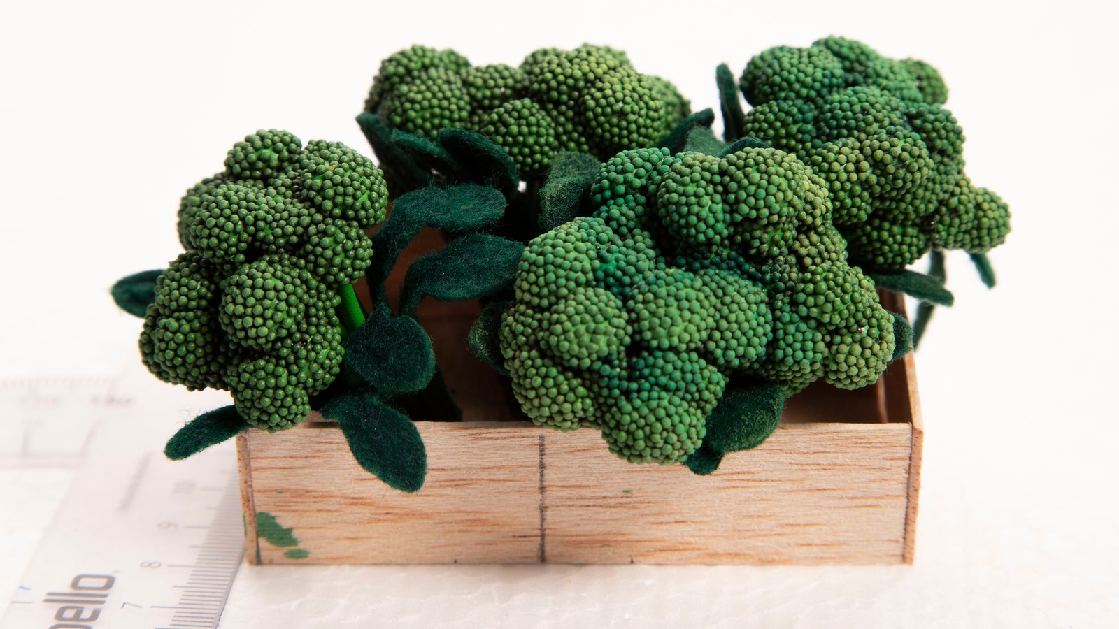 Handmade miniature broccoli in a crate