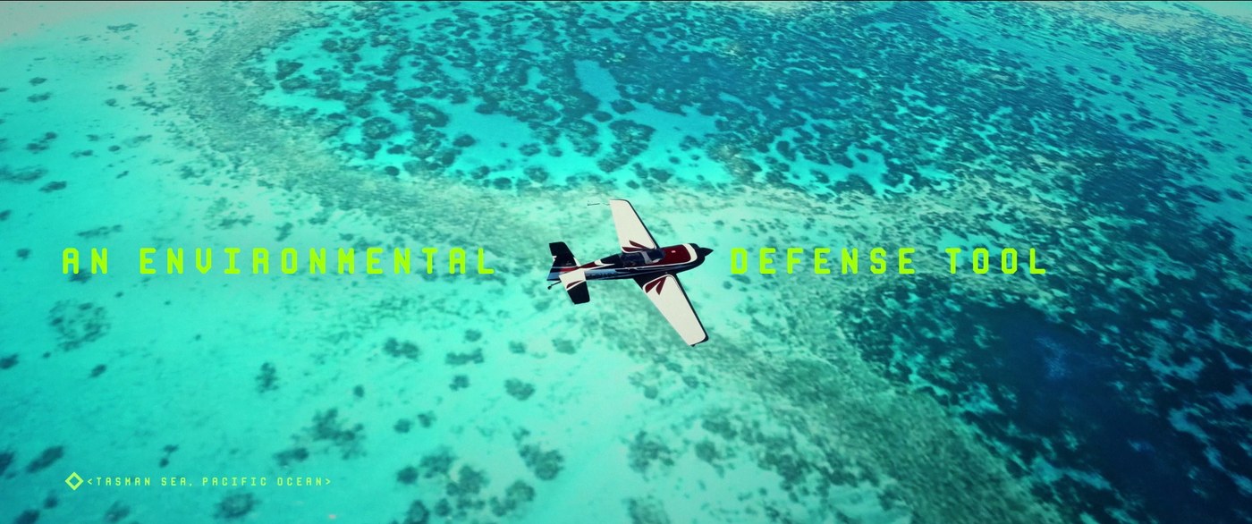 A plane over a turquoise reef, the words an environmental defence tool
