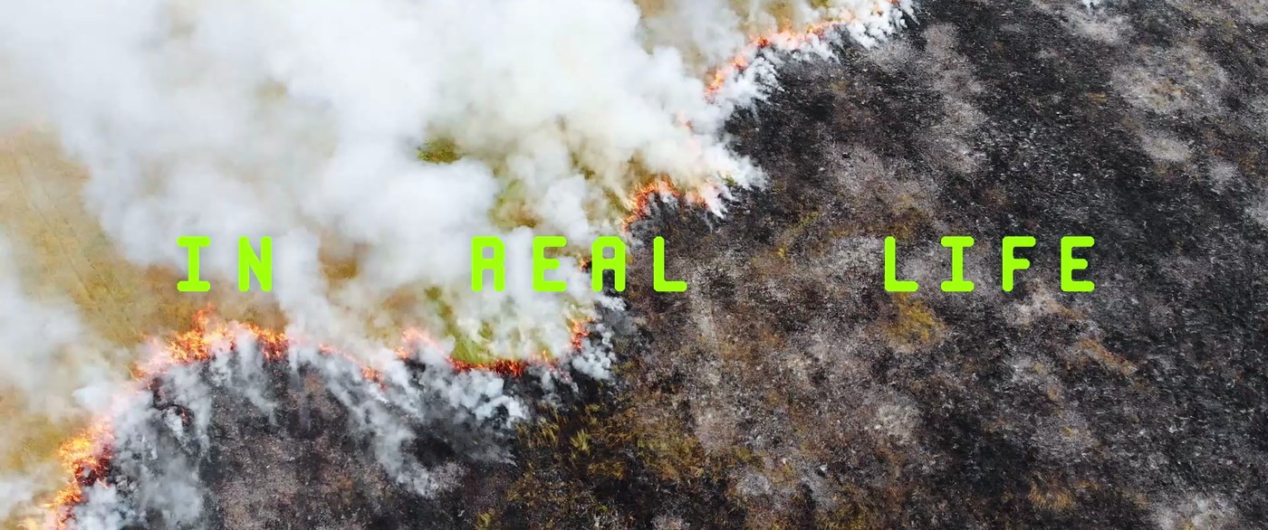 A close aerial of scarred ground, the words in real life