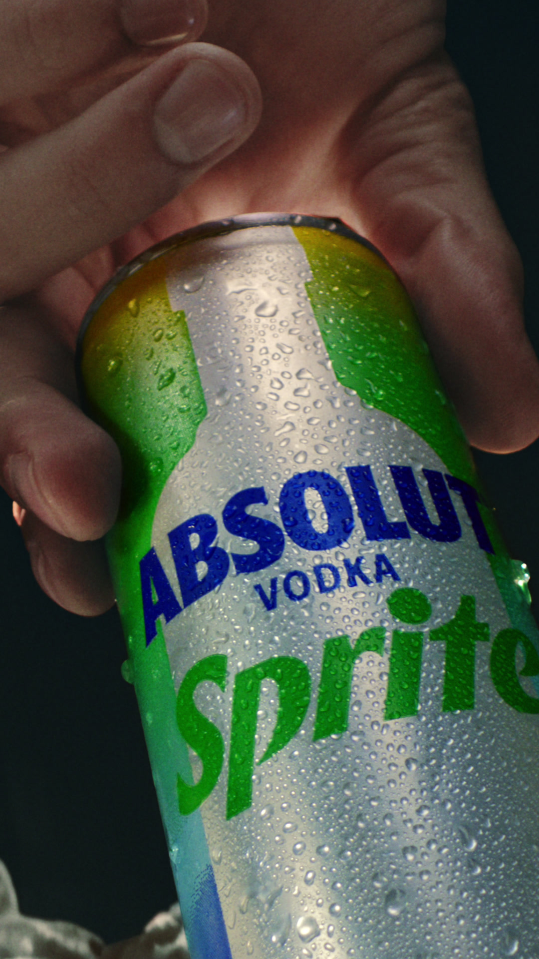A hand pulls a chilled Absolut Sprite can from an ice-filled backpack, vertical film by LOBO