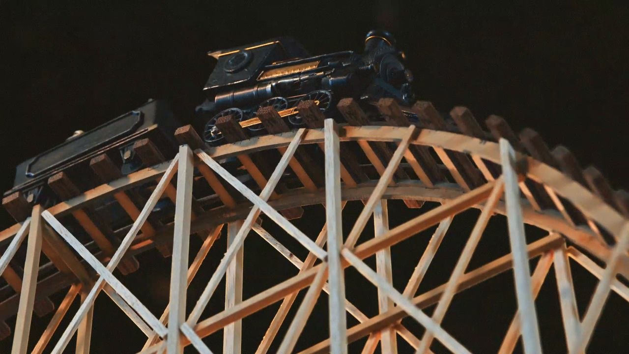 A model train crossing a hand-built balsa trestle in Eisenbahn The Beauty of the Process
